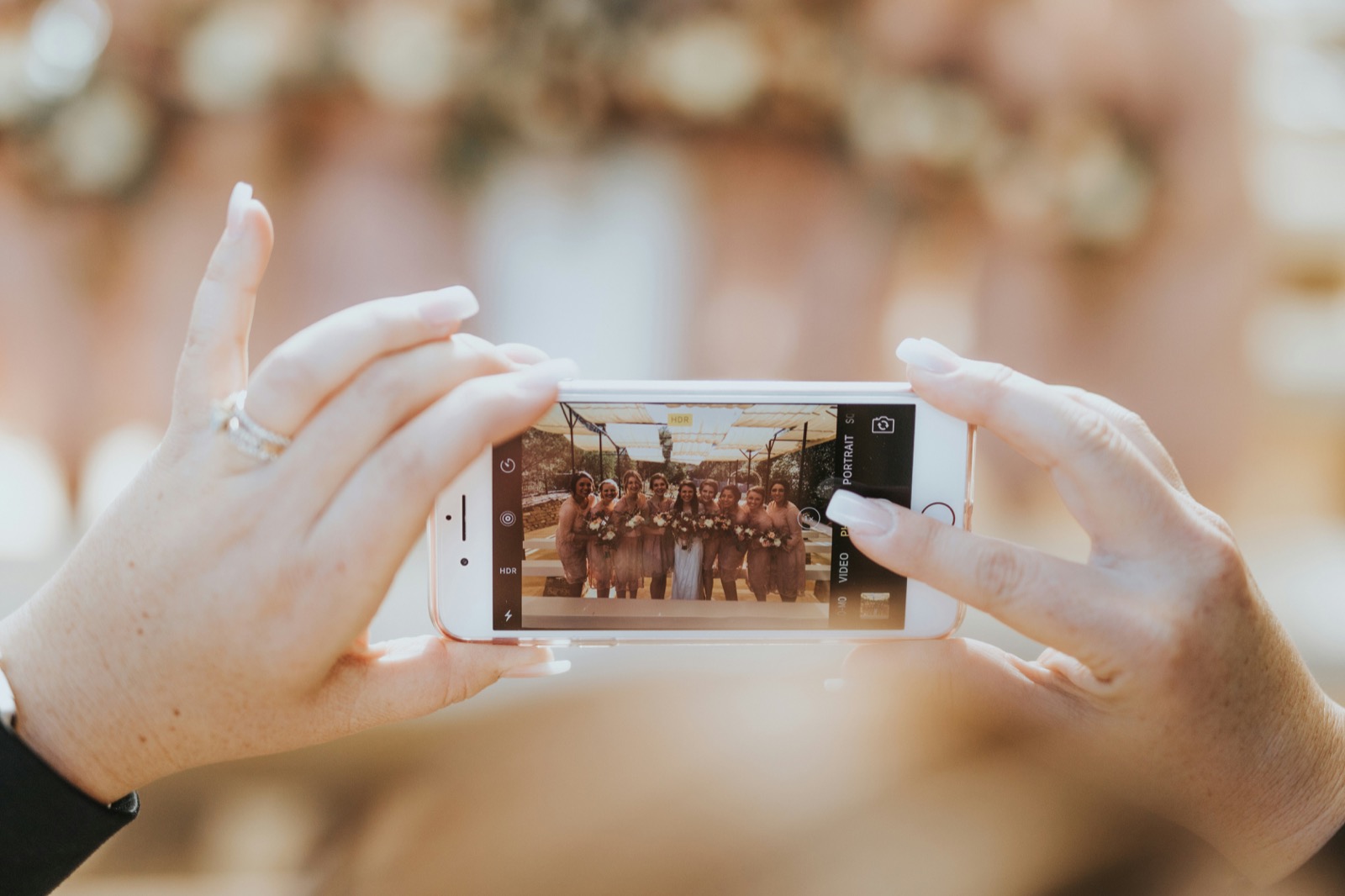 Guest photographing friends on their phone at an event